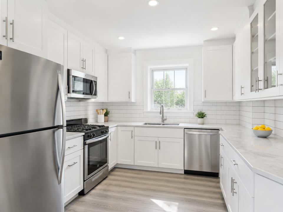 Bright white kitchen with stainless appliances